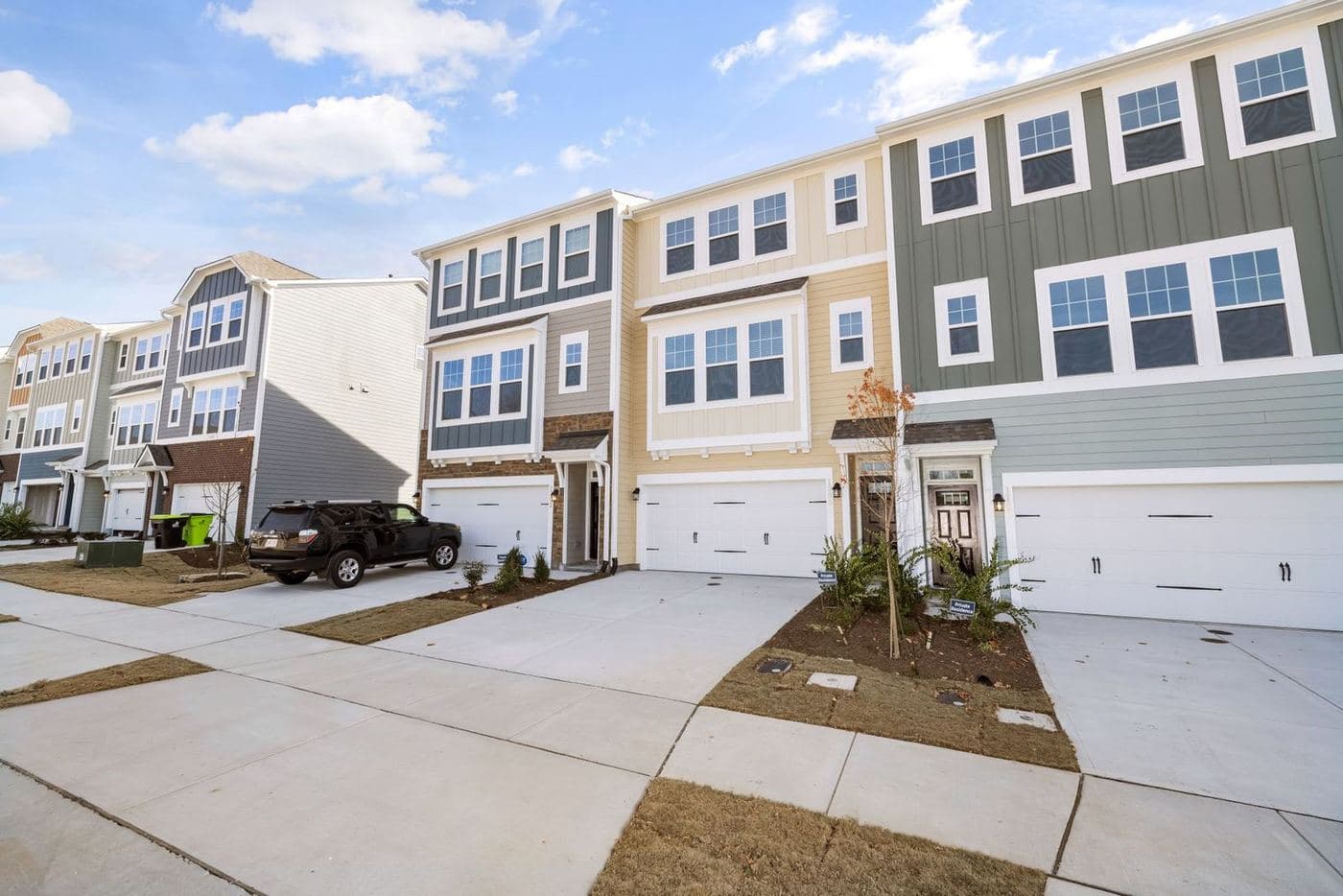 Row of newly built three-story townhomes with rear-load garages